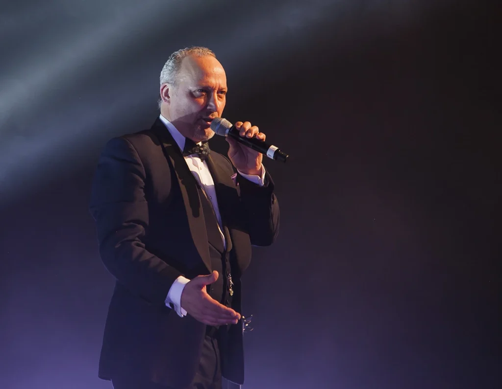 Peter Corry MBE on stage performing